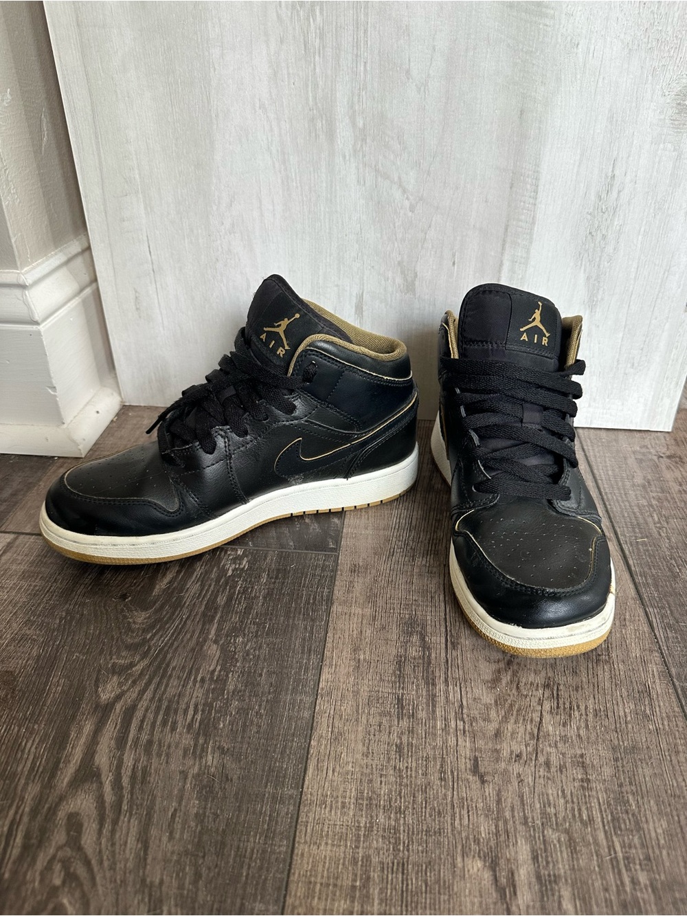 Jordan Mid-Top Sneakers in Black and Gold Accents